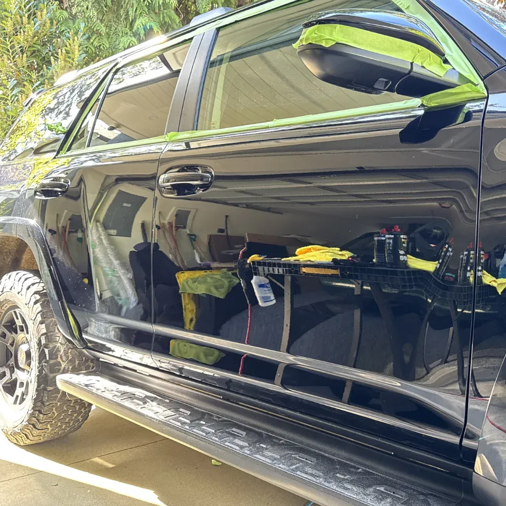 Swirled black Toyota 4Runner paint compared with the same panels after a two-step polish